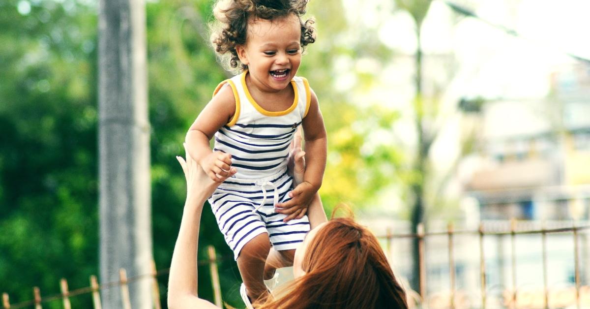 A mom and son playing outside.