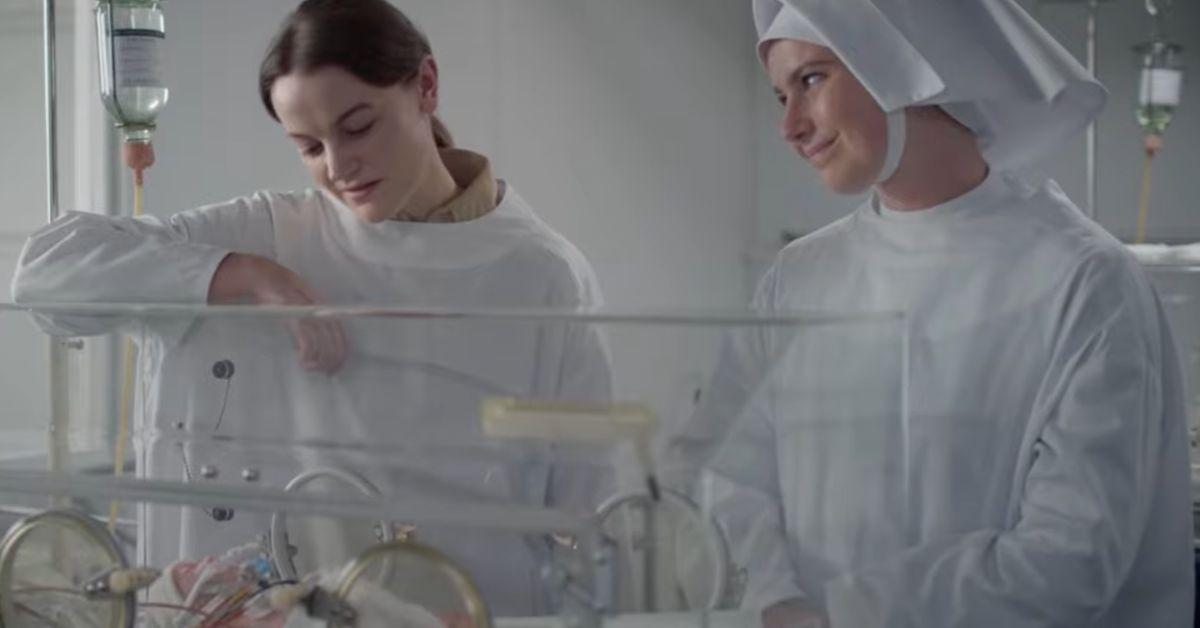 Midwives Looking Over a Baby