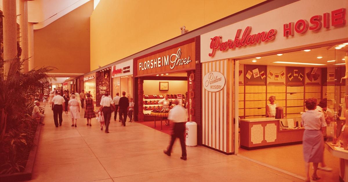  CIRCA 1960's: Interior of commercial retail mall, people shopping and walking.