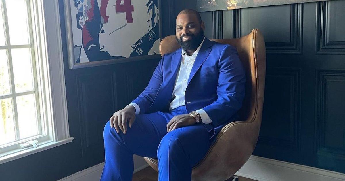 Retired NFL player Michael Oher sitting in a chair