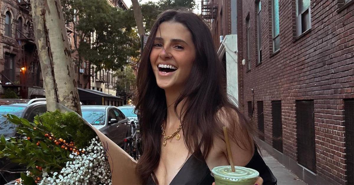 Rachel Yaffe holding a drink on a street in New York. 