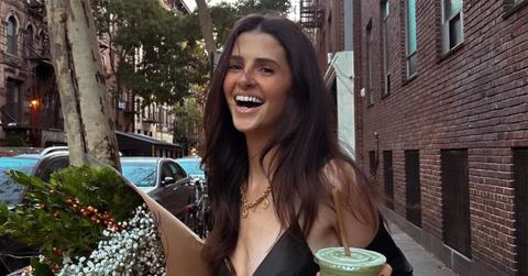 Rachel Yaffe holding a drink on a street in New York.