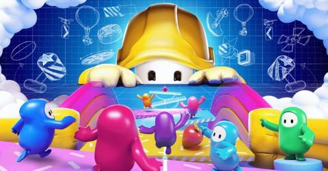 A Fall Guys character wearing a hard hat looking out over a bunch of other characters.