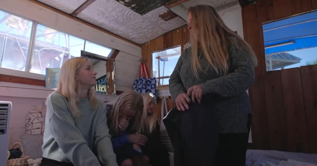 Kim Plath, and her three youngest kids, Amber, Cassia, and Mercy, sitting in the houseboat.