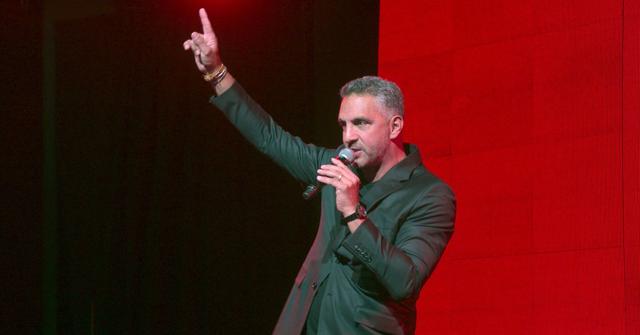'Buying Beverly Hills' Mauricio Umansky speaking into a microphone while gesturing/point upward