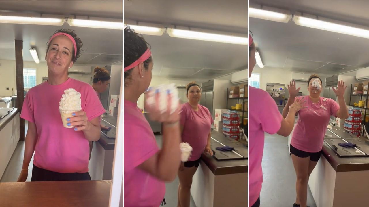 An employee throws whipped cream at another employee during the TikTok ice cream challenge