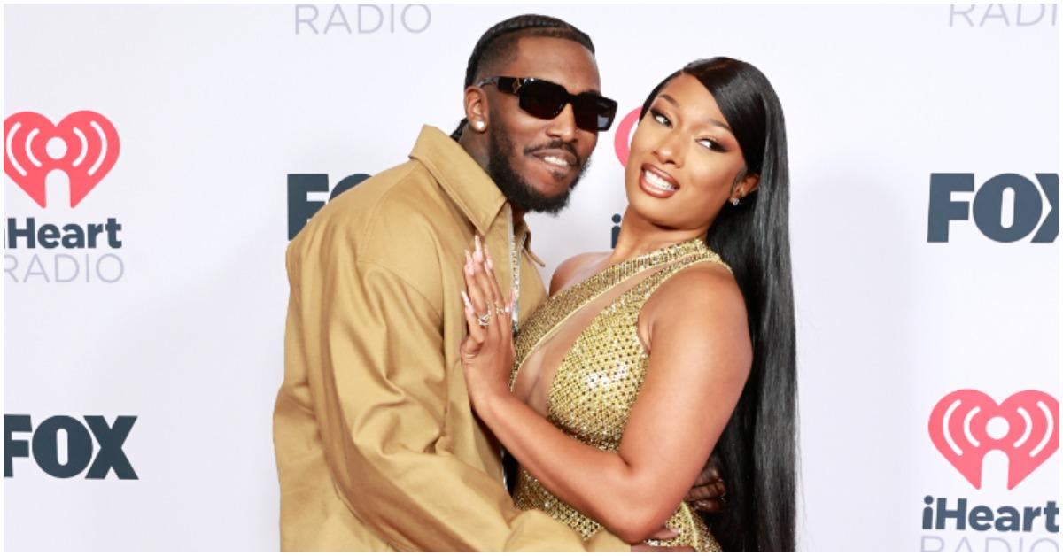 (l-r): Pardison Fontaine and Megan Thee Stallion embracing and smiling on the red carpet. 