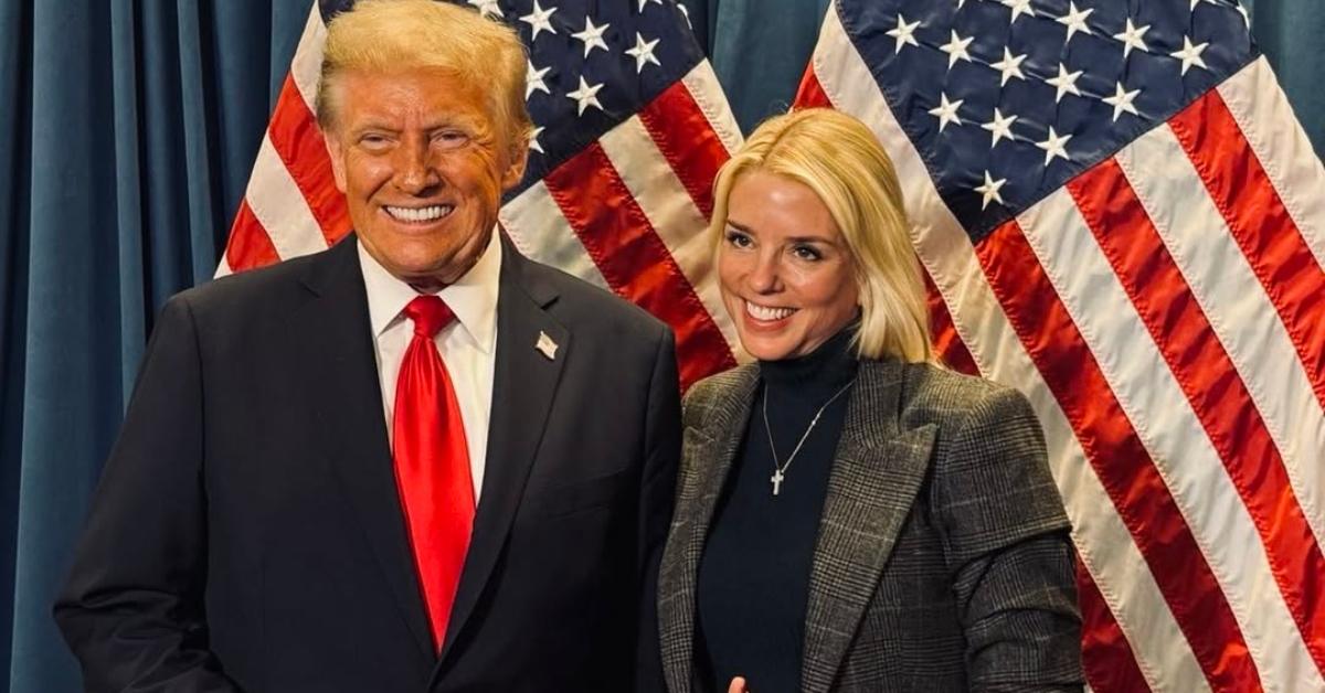 Donald Trump and Pam Bondi stand in front of an American flag