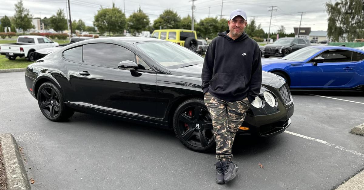 Captain Jake Anderson leaning against a black car.