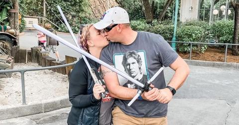 Rebecca and Jason Yarros holding light sabers