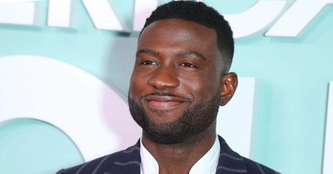 Still shot of Sinqua smiling on a red carpet.