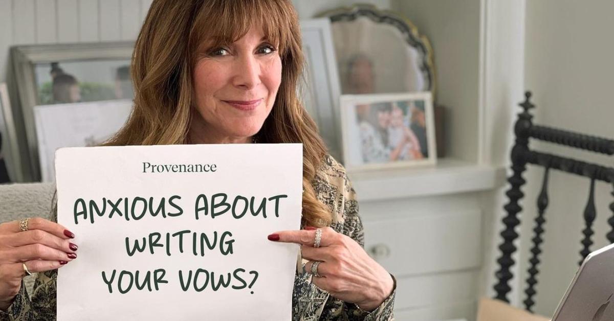 Mindy Weiss holds up a sign at her desk