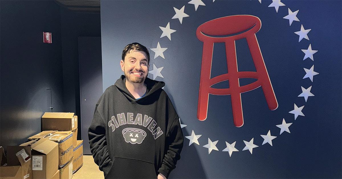 Mantis standing next to the barstool logo. 