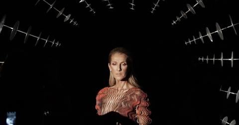 Celine Dion posing against a black backdrop.