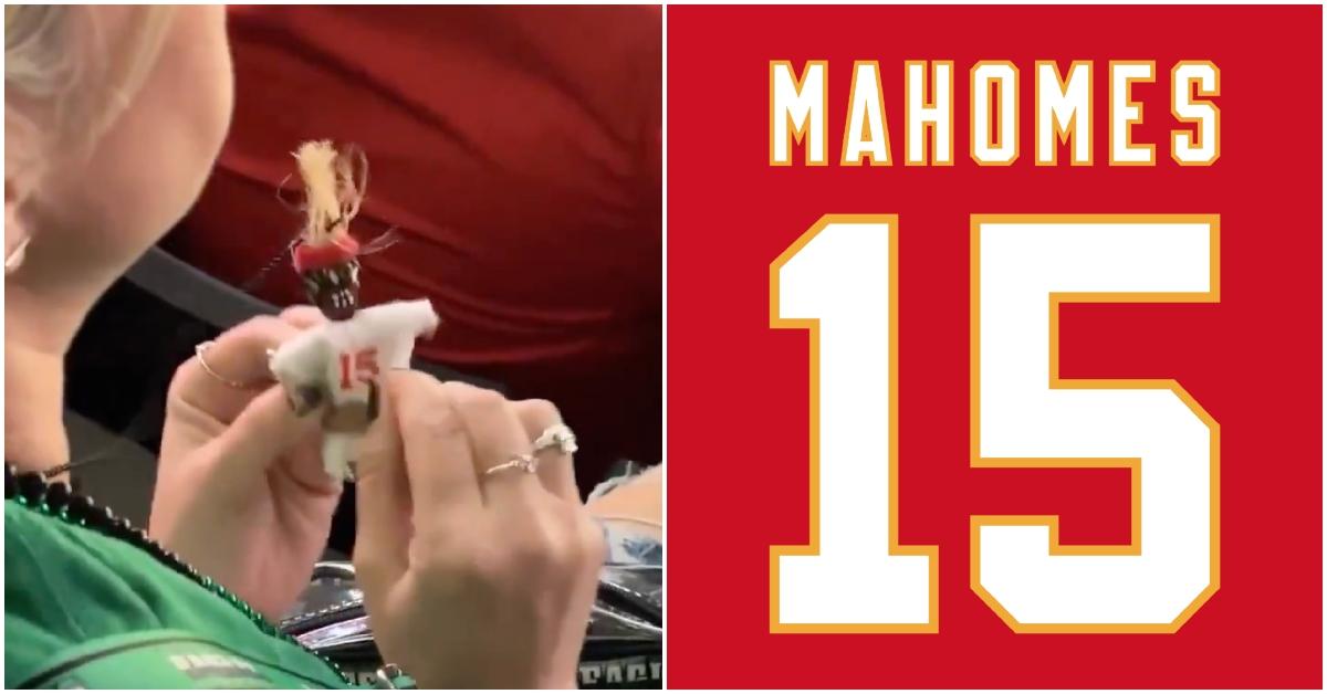 Eagles fan poking a Chiefs Voodoo doll at 2025 Super Bowl.