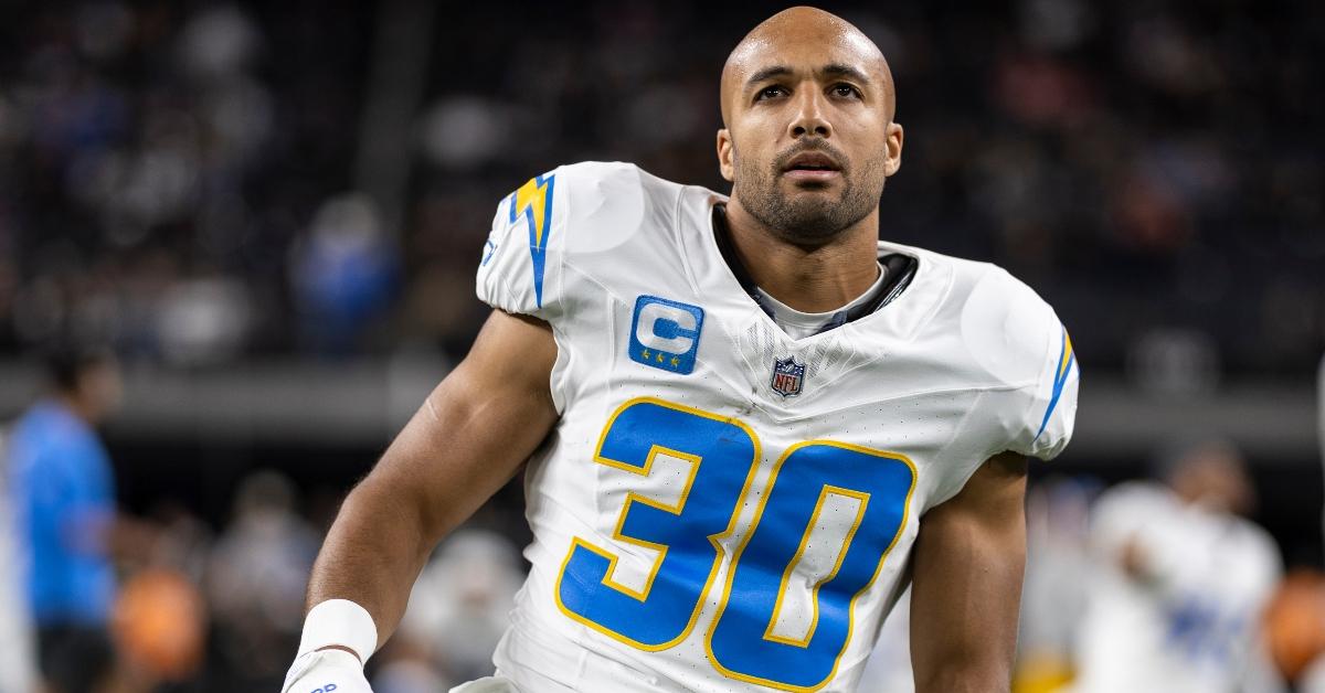 Austin Ekeler of the Los Angeles Chargers stretches as he warms up prior to an NFL game in December 2023