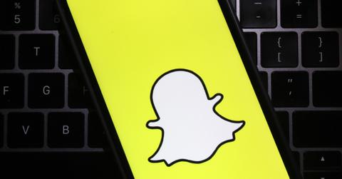 The Snapchat logo is displayed on a cell phone screen
