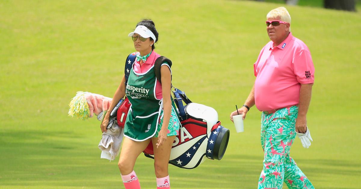 John Daly walks alongside his girlfriend/caddie Anna Cladakis during the final round of the Insperity Invitational at The Woodlands Country Club on May 8, 2016 in The Woodlands, Texas