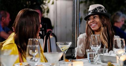 Meredith Marks and Mary Cosby speaking at a dinner table.
