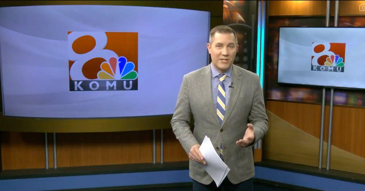 Ben Arnet in a suit and tie in front of the KOMU 8 logo. 