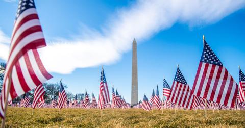 The Washington Monument with small flags in the foreground.