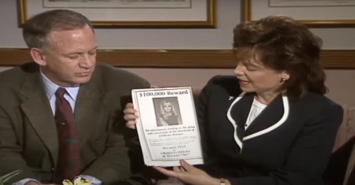 (L-R): John Ramsey and Patsy Ramsey hold up a flyer offering a reward for any information about the murder of JonBenét Ramsey