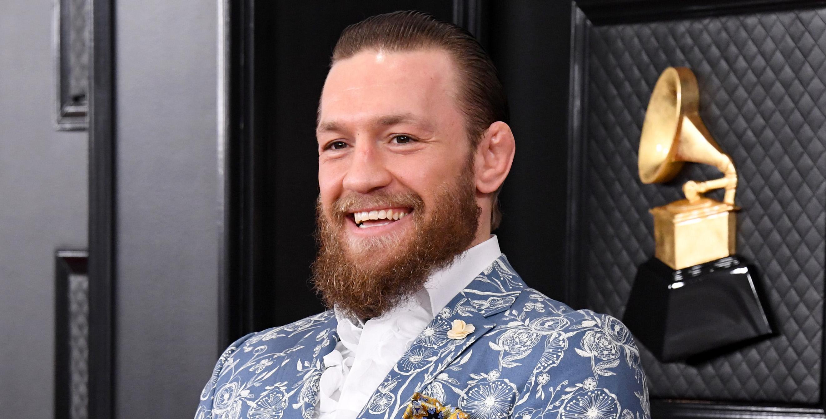 Conor McGregor in a blue and white suit.