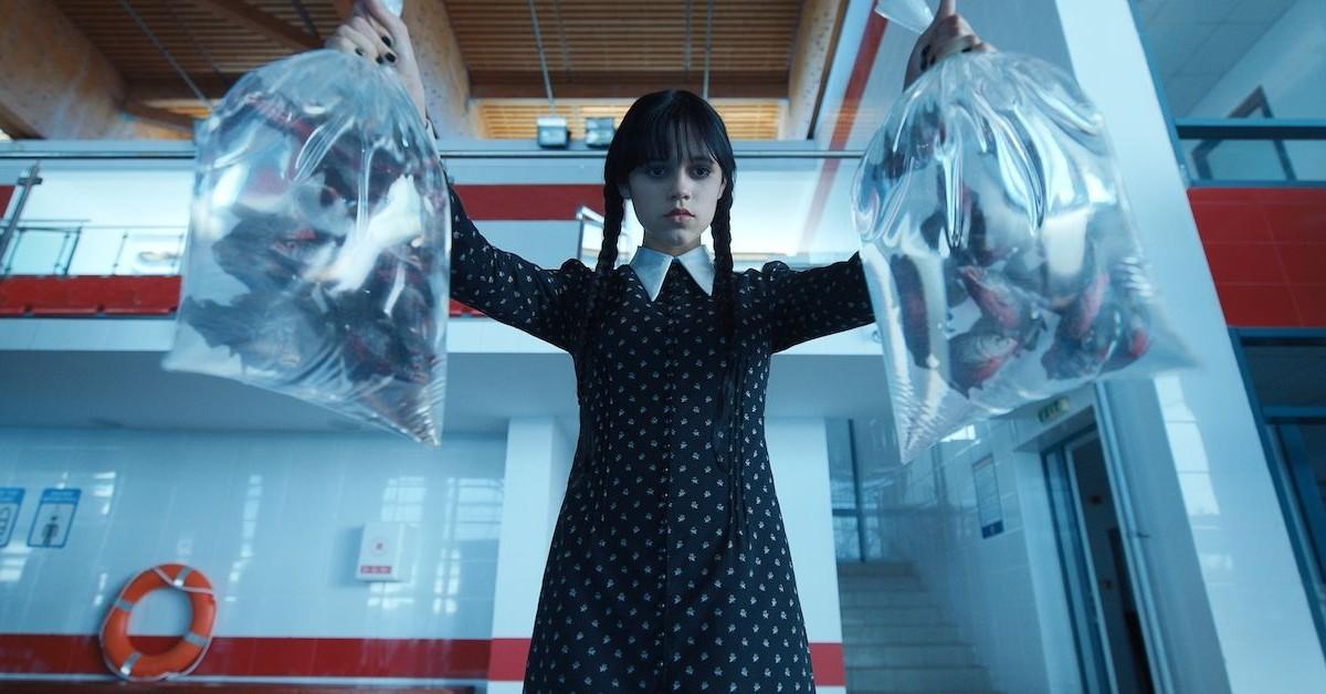 Wednesday Addams (Jenna Ortega) holding two bags of fish in 'Wednesday'