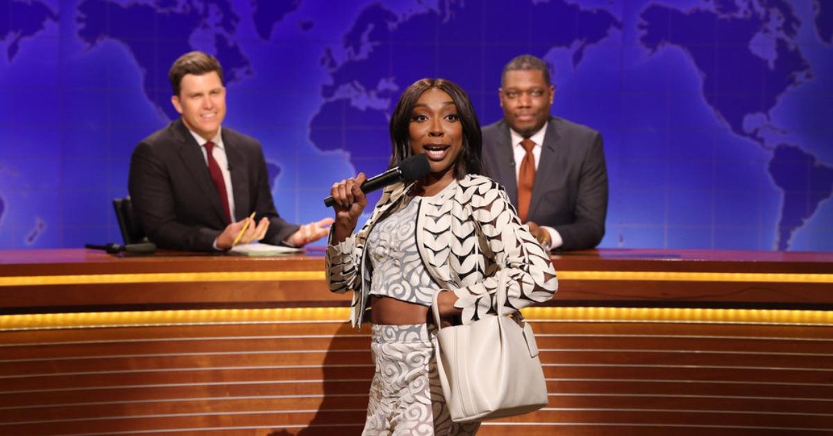 (l-r): Anchor Colin Jost, Ego Nwodim as Miss Eggy, and Michael Che