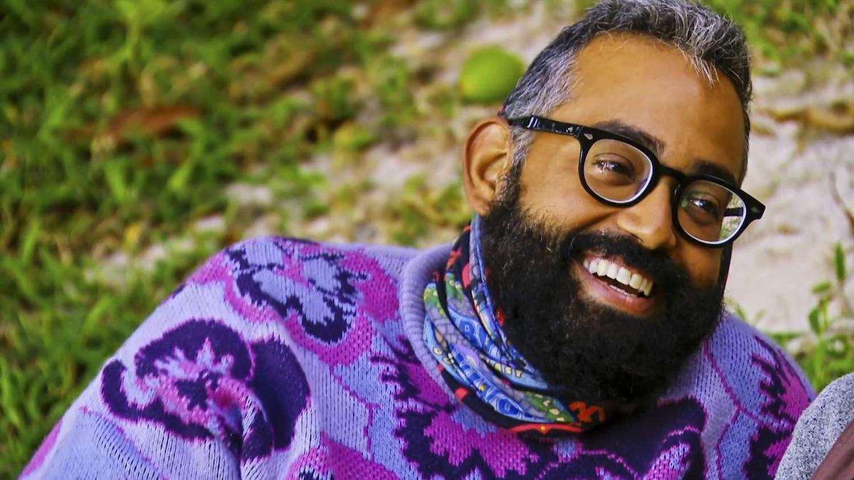 Yam Yam Arocho in a purple flower sweater and glasses in 'Survivor 44'