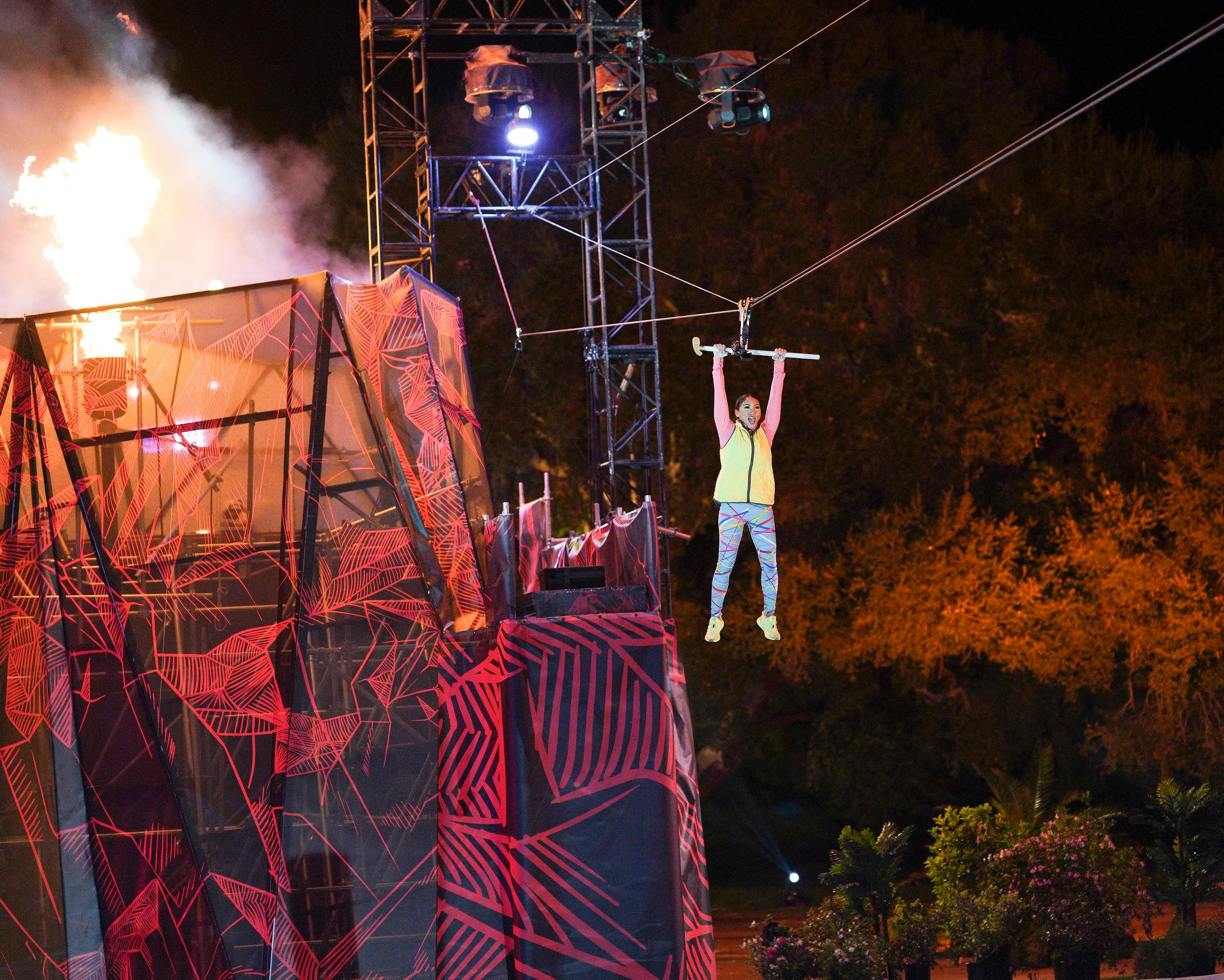 A contestant uses the zipline on Season 4 of 'Holey Moley.'