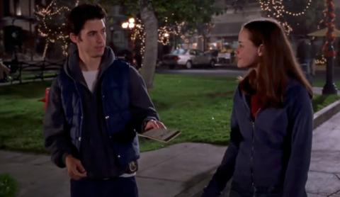 Jess hands Rory a book