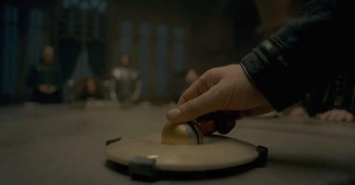 A hand touches a stone ball in 'House of the Dragon.'