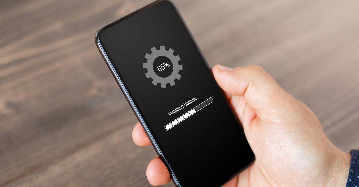 A black iPhone that is installing updates. 