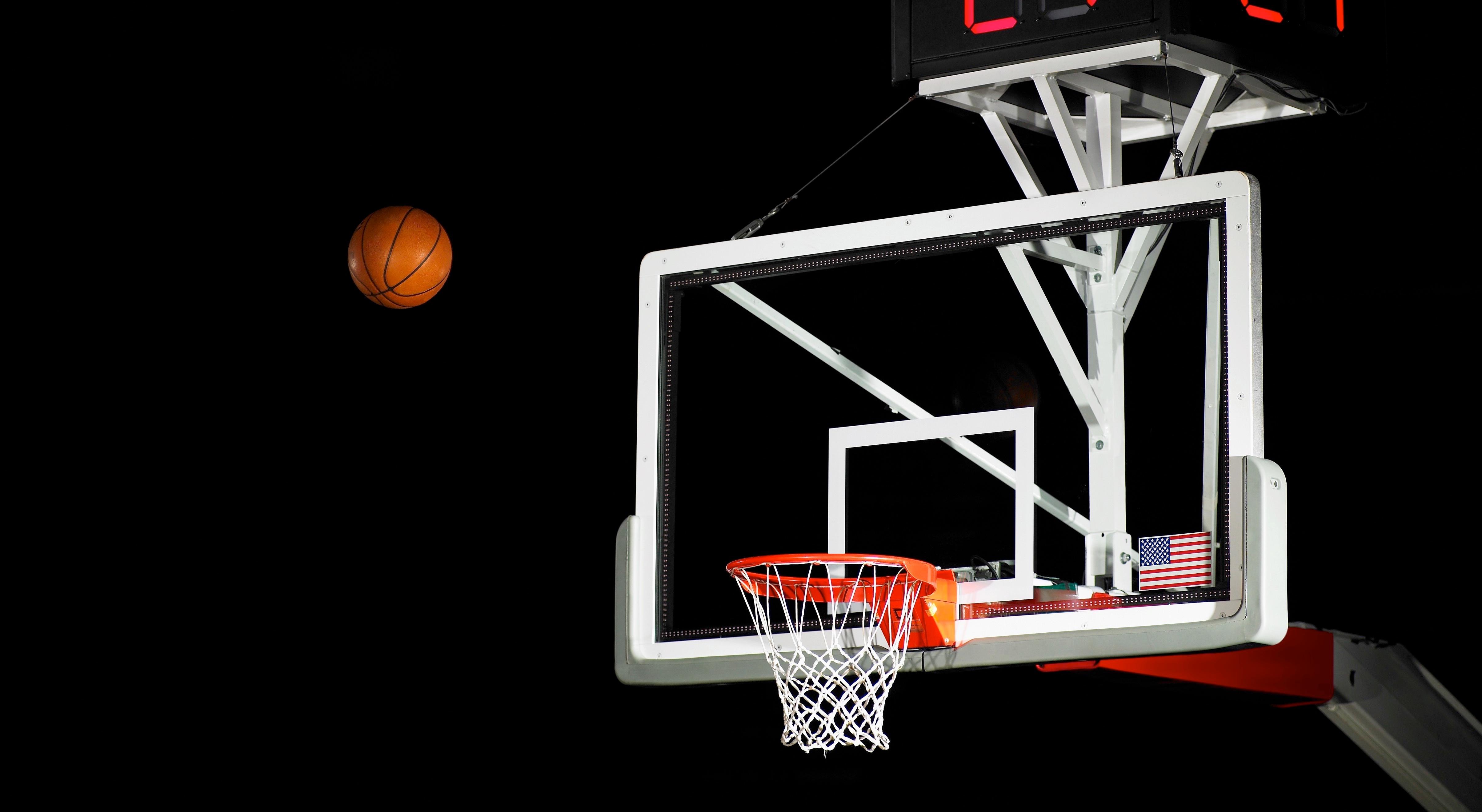 A basketball aims for the hoop.