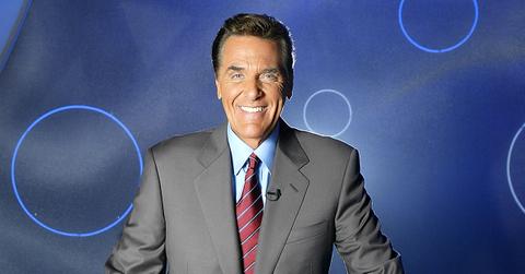 Chuck Woolery posing as the host of 'The Show.'
