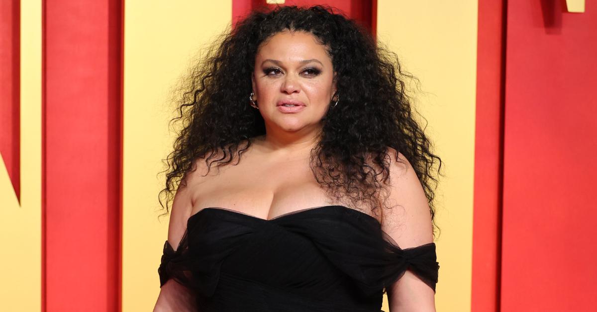 Michelle Buteau, donning an off-the-shoulder black gown, poses on the red carpet at the 2024 Vanity Fair Oscar Party on March 10, 2024, in Beverly Hills.