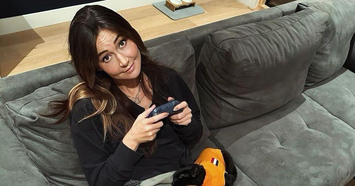 Jessica Chobot sitting on her couch with her dogs