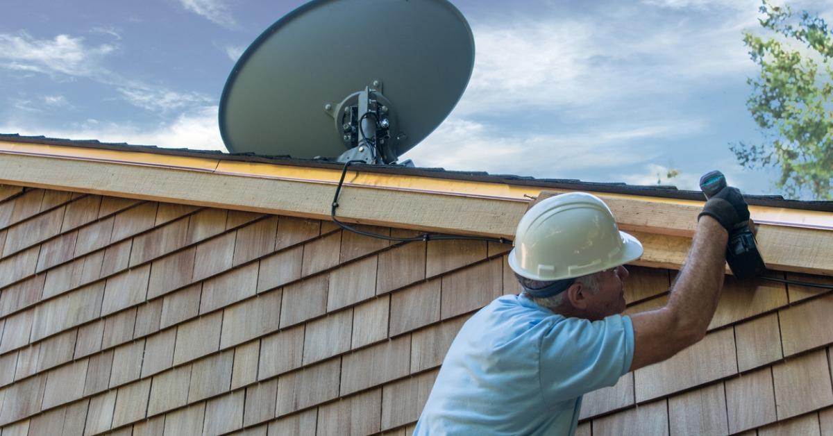 man installing satellite dish picture id