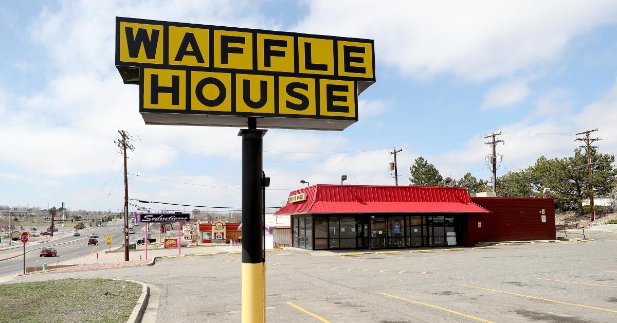 a waffle house and parking lot and sign