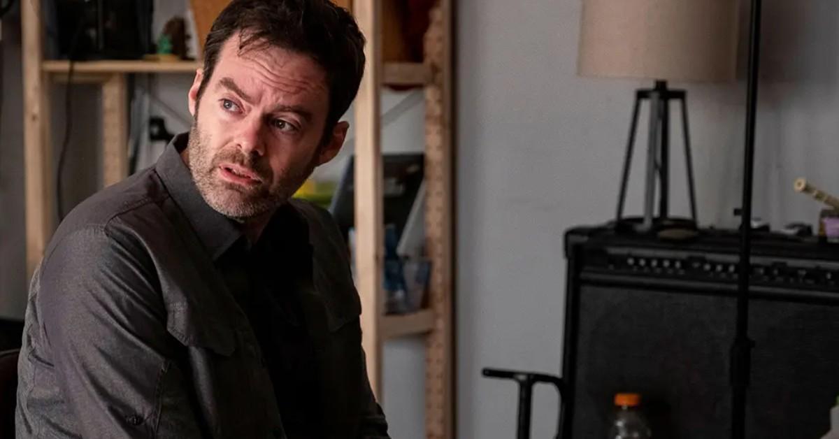 Barry (Bill Hader), clad in a black coat, looks to his left with a concerned gaze.