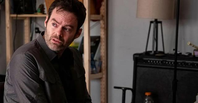 Barry (Bill Hader), clad in a black coat, looks to his left with a concerned gaze.