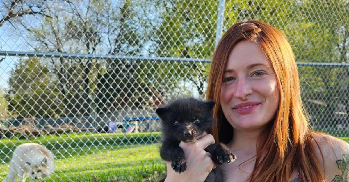 Mikayla Raines holding a fox. 