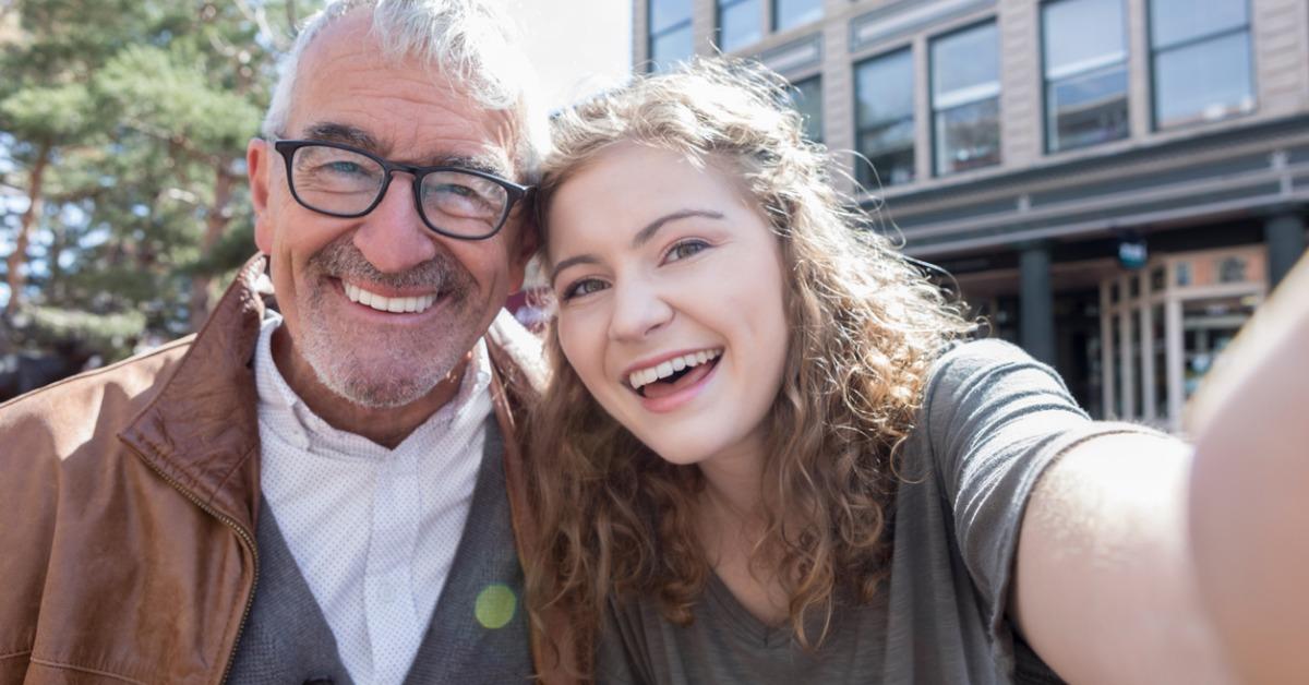 teenage girl takes selfie with grandfather picture id