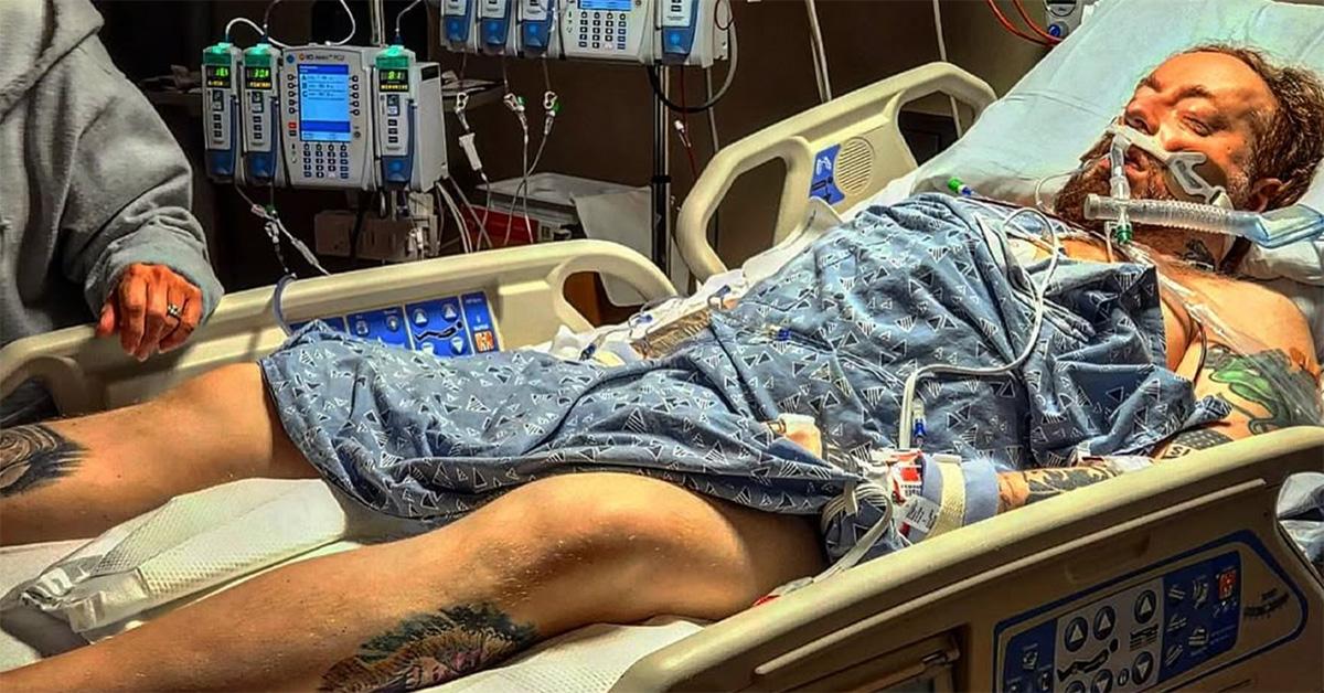 Rittz lying in a hospital bed with tubes around his mouth. 