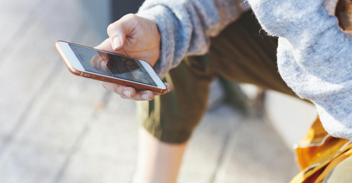 woman holding an iPhone