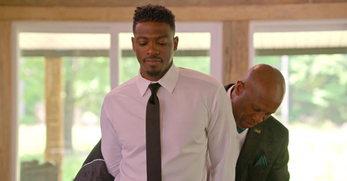 Clay Gravesande's dad, Trevor, helps him put on his suit jacket on his wedding day in Season 6 of 'Love Is Blind.'