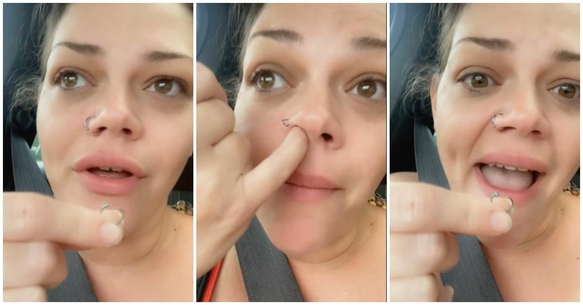 A woman showing how she accidentally swallowed her nose ring in her sleep.