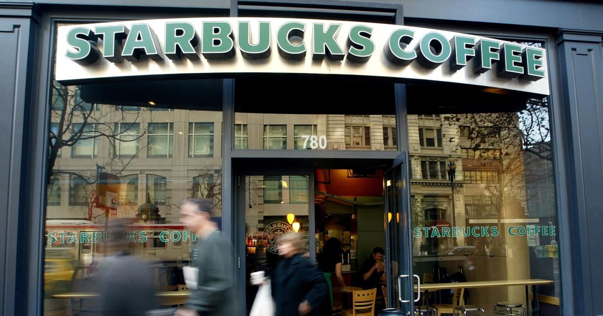 People walking by the front of a Starbucks location