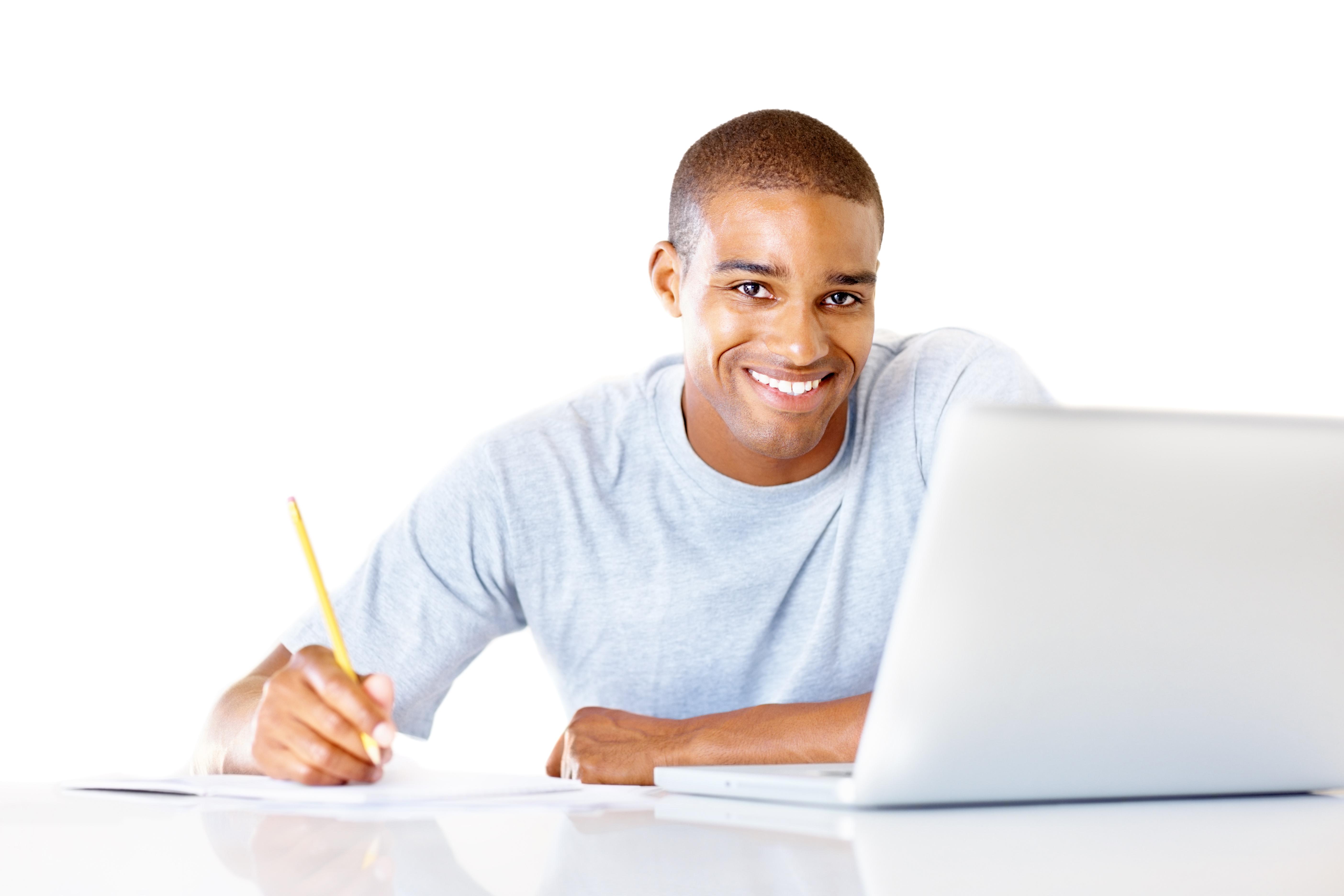 man sitting at laptop holding a pencil and smiling